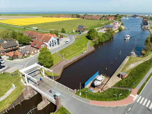 an aerial view of a river with a town at Nordseehotel Tausendschön in Carolinensiel