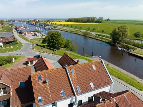 arial view of a town with a river and houses at Nordseehotel Tausendschön in Carolinensiel