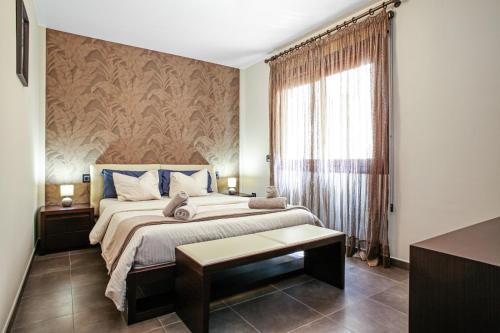 a bedroom with a large bed and a window at Apartments Alba in El Médano