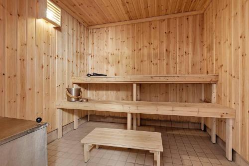a wooden sauna with a bench and a table at Old Post Office now cosy apartment close to nature in Hedenäset