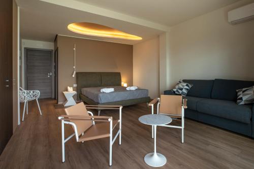 a living room with a couch and a bed at Hotel Belvedere Resort in Castellammare del Golfo