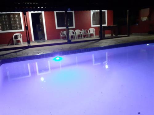 an empty swimming pool with a green light in it at CHACARA ENCANTO DO VALE in Mairinque