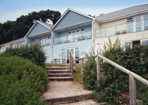 a house with stairs in front of it at Red Rock Apartments in Dawlish