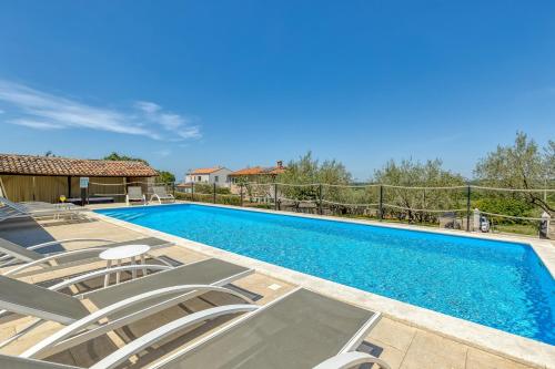 a villa with a swimming pool and chairs at Villa Luna in Selina in Selina