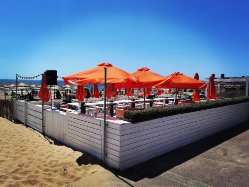 a table with an umbrella on the beach at Sweet Dreams of Bournemouth in Bournemouth