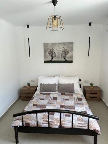 a bedroom with a bed with a quilt on it at Kouzoulis House in Éxo Khóra
