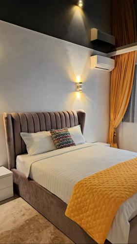 a bedroom with a large bed with a headboard at KYA Luxury in Mamaia