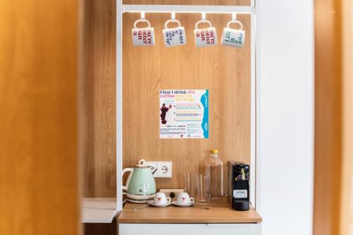 a kitchen with a counter with a shelf with clocks at Hotel Kitchen59 in Sofia
