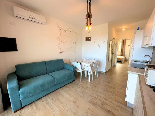 a living room with a couch and a table at Affittimoderni Isola Rossa Cala Serena - PASE02 in Cascabraga