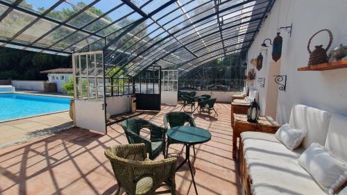 a patio with a glass roof over a swimming pool at Château Belle Epoque - Chambres d'Hôtes & Gîtes in Linxe
