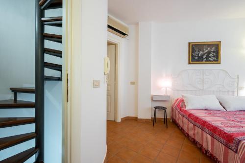a bedroom with a bed with a red blanket at Castelmola Casa Chiocciola with Terraces in Castelmola