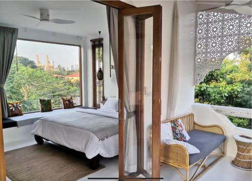 a bedroom with a bed and a large window at lory‘s home in Bangkok