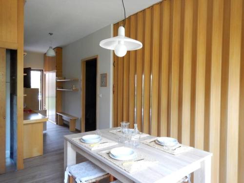 a dining room with a white table with plates on it at VOLTA Pool&Beach apartment in Bardolino
