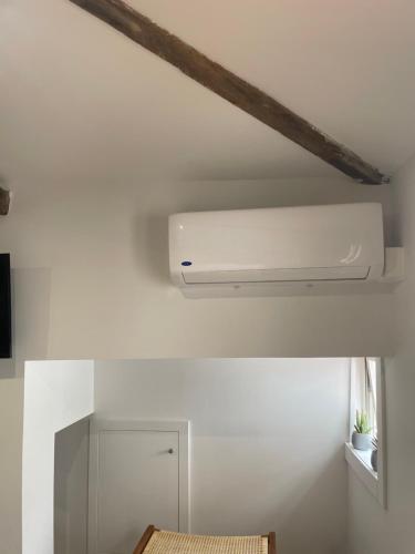 a white ceiling fan in a white room at A Das Marias Small in Ourense