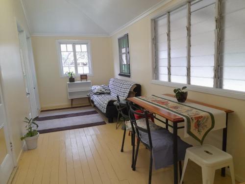 a living room with a table and a couch at Home at the beach in Ingham in Allingham