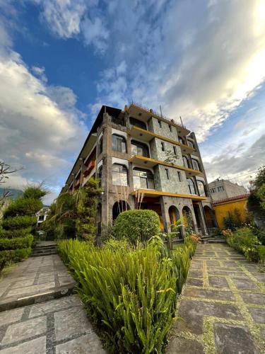 a tall building with plants in front of it at Hotel Tiosh Abaj in Santiago Atitlán