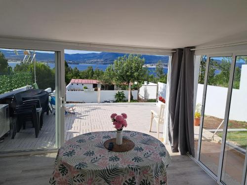 a room with a table and a view of a patio at A Casiña do Antonio in Nigrán