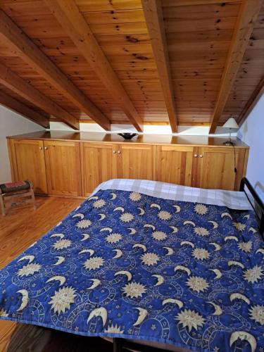 a bedroom with a bed with a blue comforter at Villa Anesis-Παραθαλάσσια βίλα in Amaliás