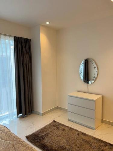 a bedroom with a dresser and a mirror on the wall at Modern studio in the heart of Amman in Amman