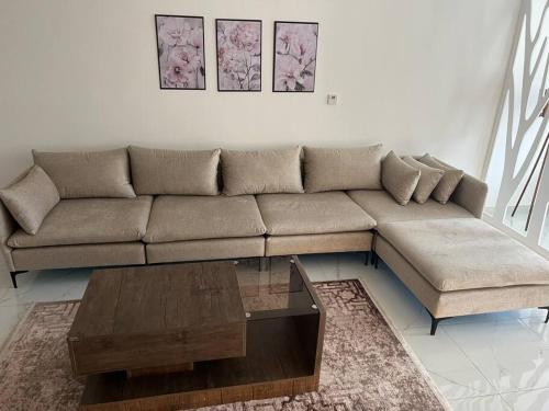 a living room with a couch and a coffee table at Modern studio in the heart of Amman in Amman