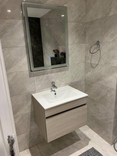 a bathroom with a sink and a mirror at Modern studio in the heart of Amman in Amman