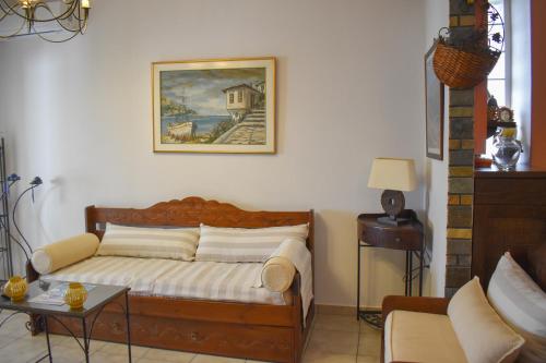 a bedroom with a bed and a picture on the wall at The GL place in Iraklitsa