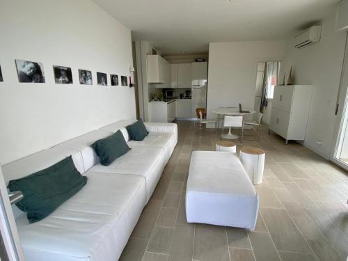 sala de estar con sofá blanco y mesa en Residence Luna, en Lignano Sabbiadoro