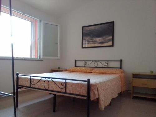 um quarto com uma cama num quarto com uma janela em Casa Vacanze em Santa Caterina