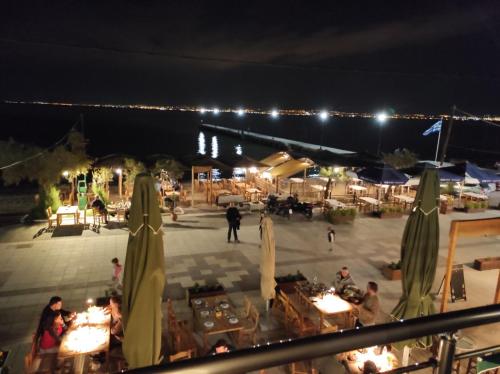 a view of a patio with tables and umbrellas at night at Casa la Scala in Agia Triada
