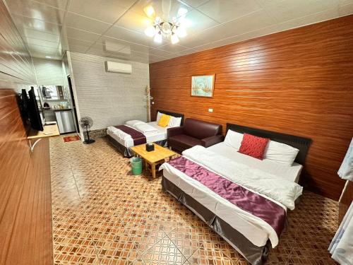 a hotel room with two beds and a couch at Taroko Little Fish in Xincheng