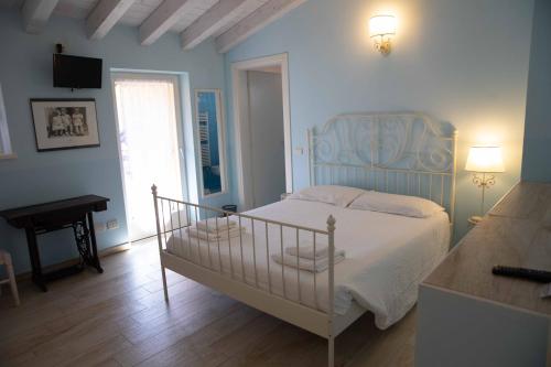 a bedroom with a bed and a table and a piano at Borgo alla Sorgente in Vallio Terme