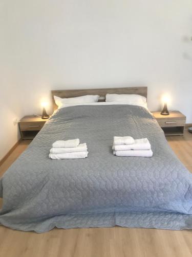 a bedroom with a bed with towels on it at Nick's place-brandnew, central and quiet apt by Margit bridge in Budapest