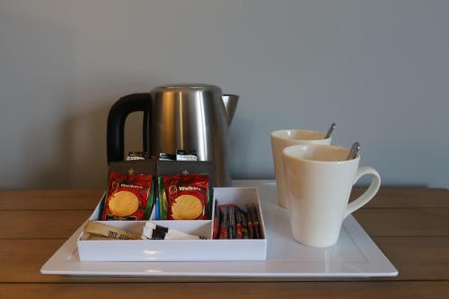 a tray with a coffee pot and a cup of coffee at The Old Electric Store in Portree