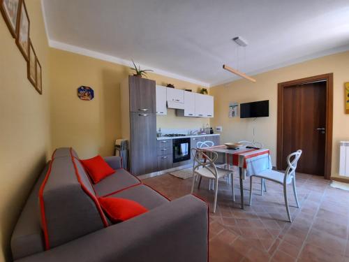 a living room with a couch and a table at Il Borghetto di San Giuseppe EtnaRooms&Apartments in Nicolosi