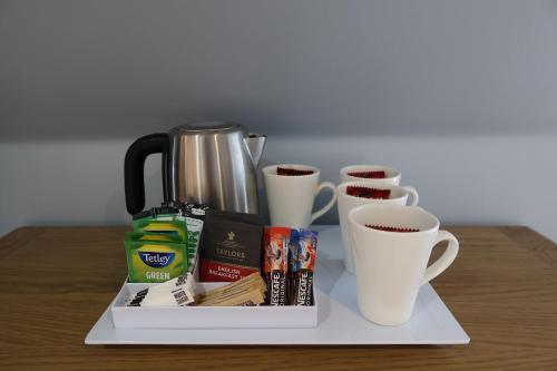 a tray with cups of coffee on a table at The Old Shop in Portree