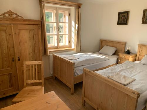 a bedroom with two beds and a window at Na Vyhlídce in Krompach