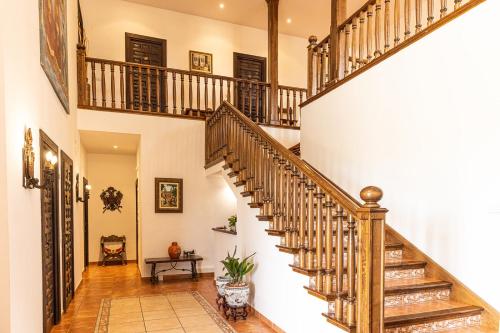 a staircase in a house with wooden railings at CASA RURAL Cigarral del Pintor in Toledo
