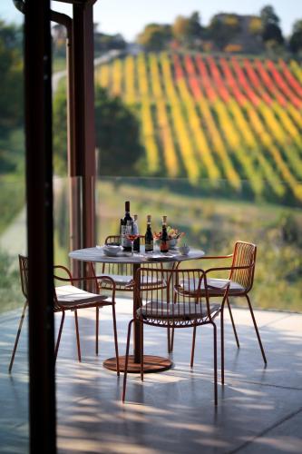 a table and chairs on a patio with a view of a field at Agriturismo Acetaia Sereni in Marano sul Panaro
