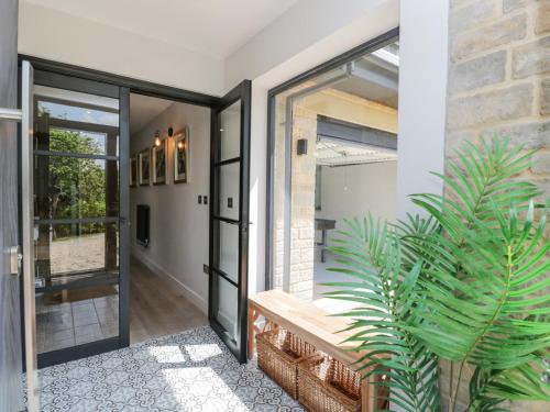 a pivot door in a house with a plant at Greystones in Gloucester