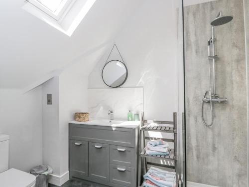 a bathroom with a sink and a mirror at Greystones in Gloucester