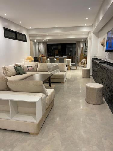 a living room with couches and tables and a living room at APPARTEMENT 3 chambres gueliz in Marrakesh