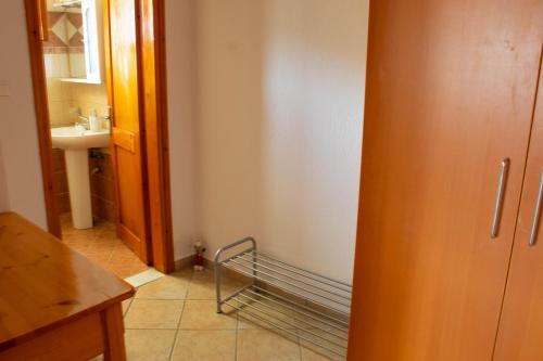 a bathroom with a sink and a towel rack at Alexandra's House in Skiathos