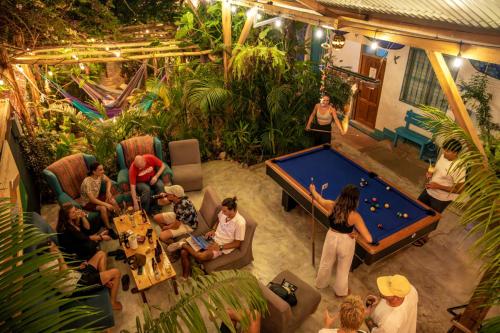 a group of people in a room with a pool table at Los Amigos Hostel in Flores