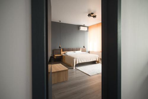 a bedroom with a white bed and a room with a bed sqor at Si-Yo hostel in Uzhhorod