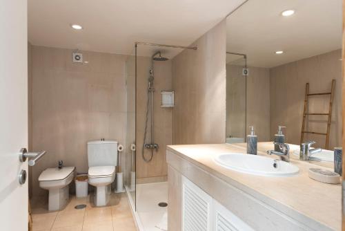 a bathroom with a toilet and a sink and a shower at Marina Vilamoura Relax Apartment in Vilamoura
