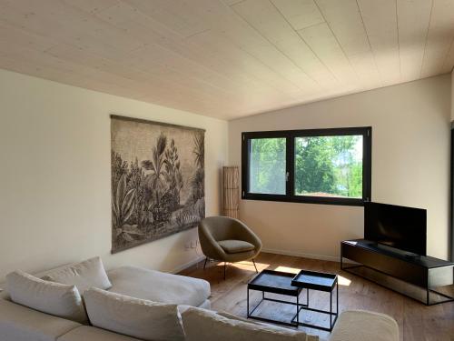 a living room with a couch and a chair at Lodge Glardons in Marin