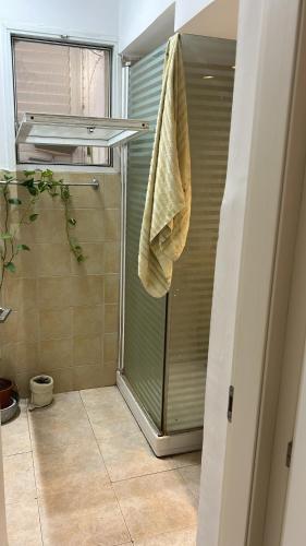a bathroom with a shower with a towel at Apartment near Hilton in Tel Aviv