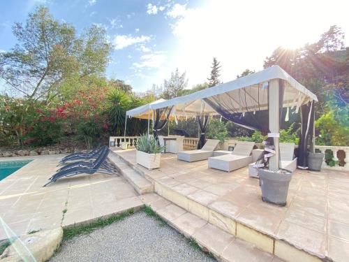 a patio with a gazebo and a pool at Villa Daurus in Vallauris