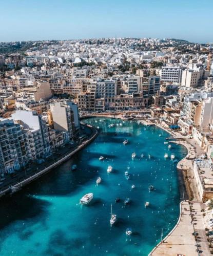 a harbor in a city with boats in the water at Ewa Apt - 3-Bedrooms Apt near Sliema - St Julians Seafront in Il-Gżira