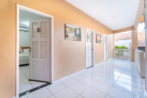 a hallway with two doors and a tile floor at Mansomar in Jericoacoara